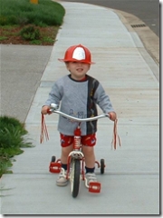 Kenny on the bike with his fire hat